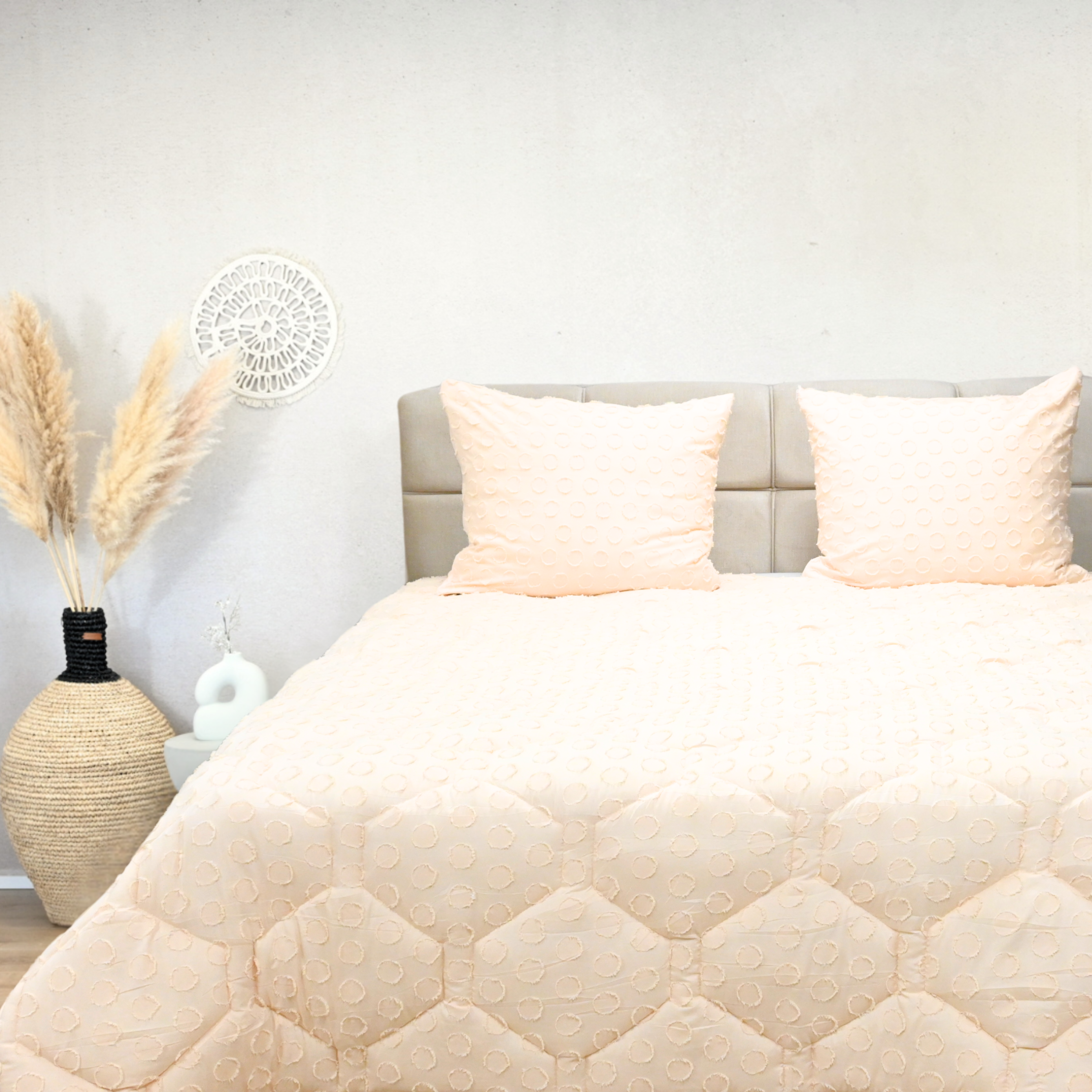 HappyBed tufted soft peach all-season duvet on bed with pillows.