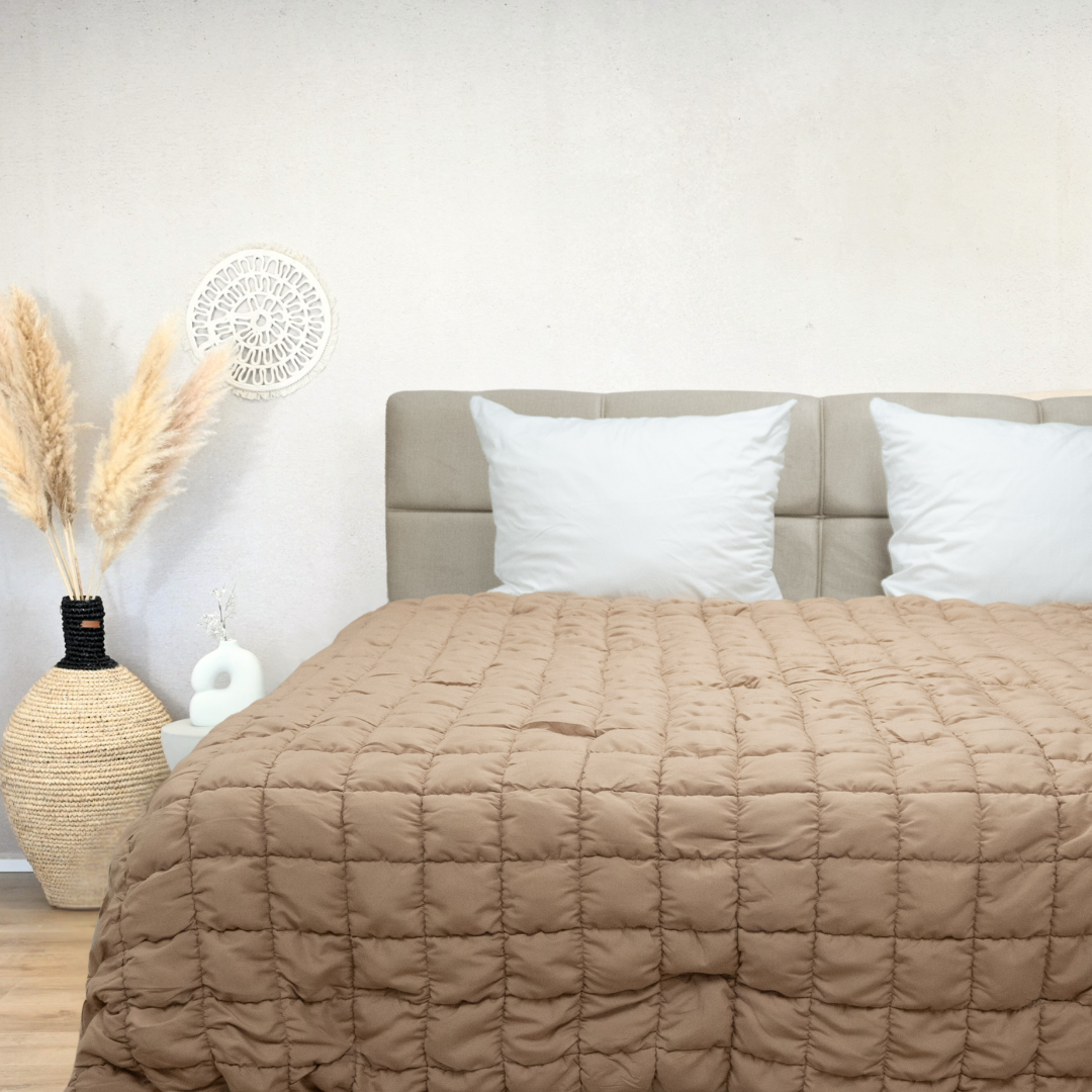 HappyBed Puffy dekbed in warm taupe on bed with beige headboard and white pillows in cozy bedroom setting