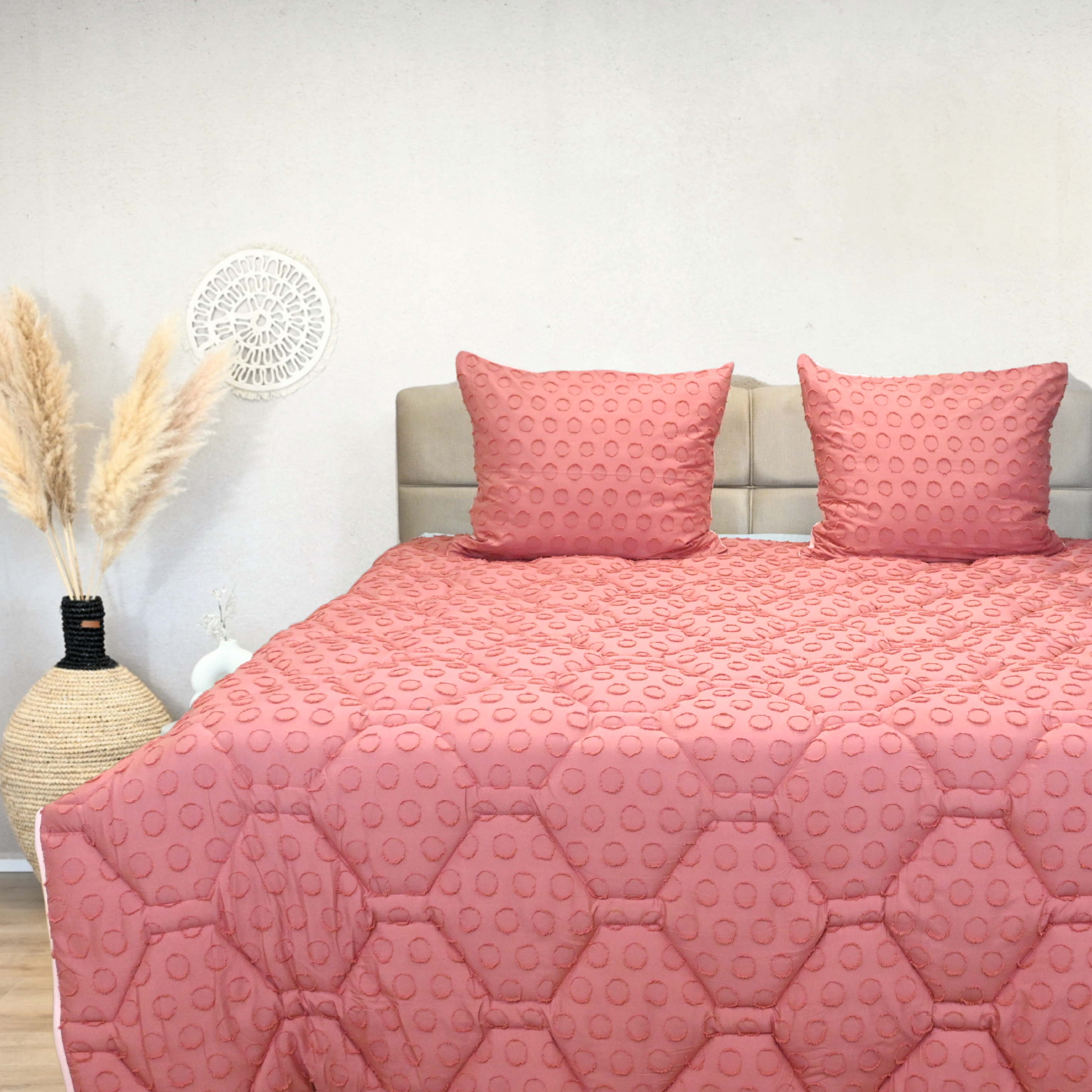 Blushed pink tufted HappyBed duvet on a beige bed.
