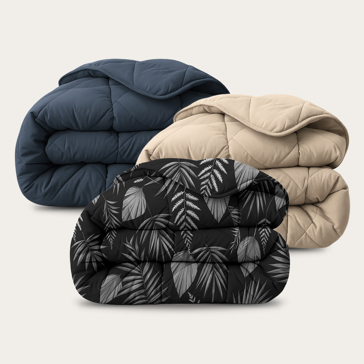 HappyBed Bestseller Bundle set van drie all-season dekbedden in taupe, donkerblauw en Black Leaves print