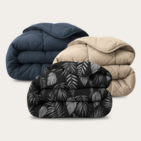HappyBed Bestseller Bundle set van drie all-season dekbedden in taupe, donkerblauw en Black Leaves print