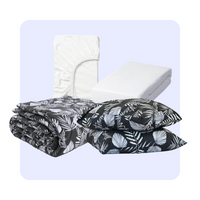 HappyBed Bundel Black Leaves bedding set with patterned duvet, matching pillowcases, white fitted sheet, and mattress protector