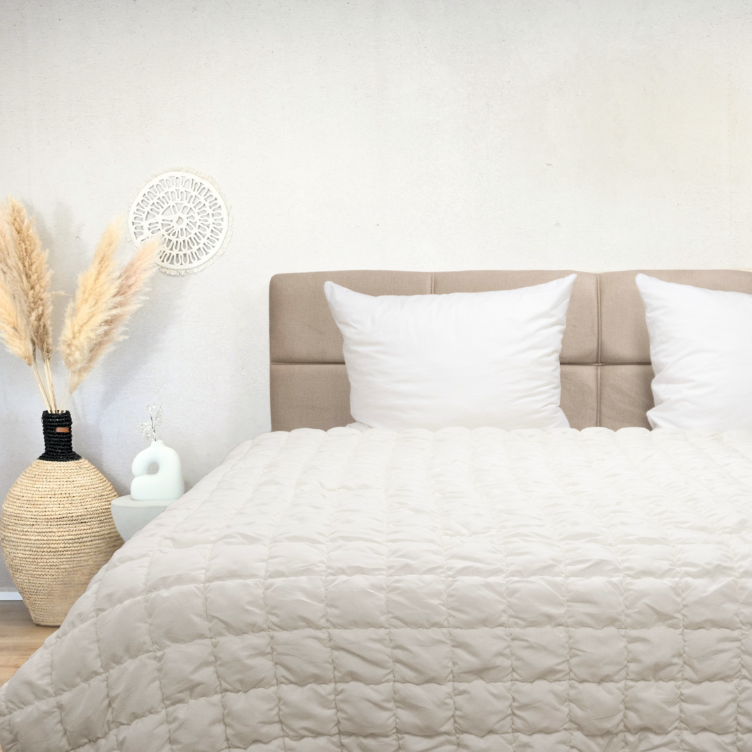 White Puffy dekbed on bed with beige headboard in stylish bedroom setting