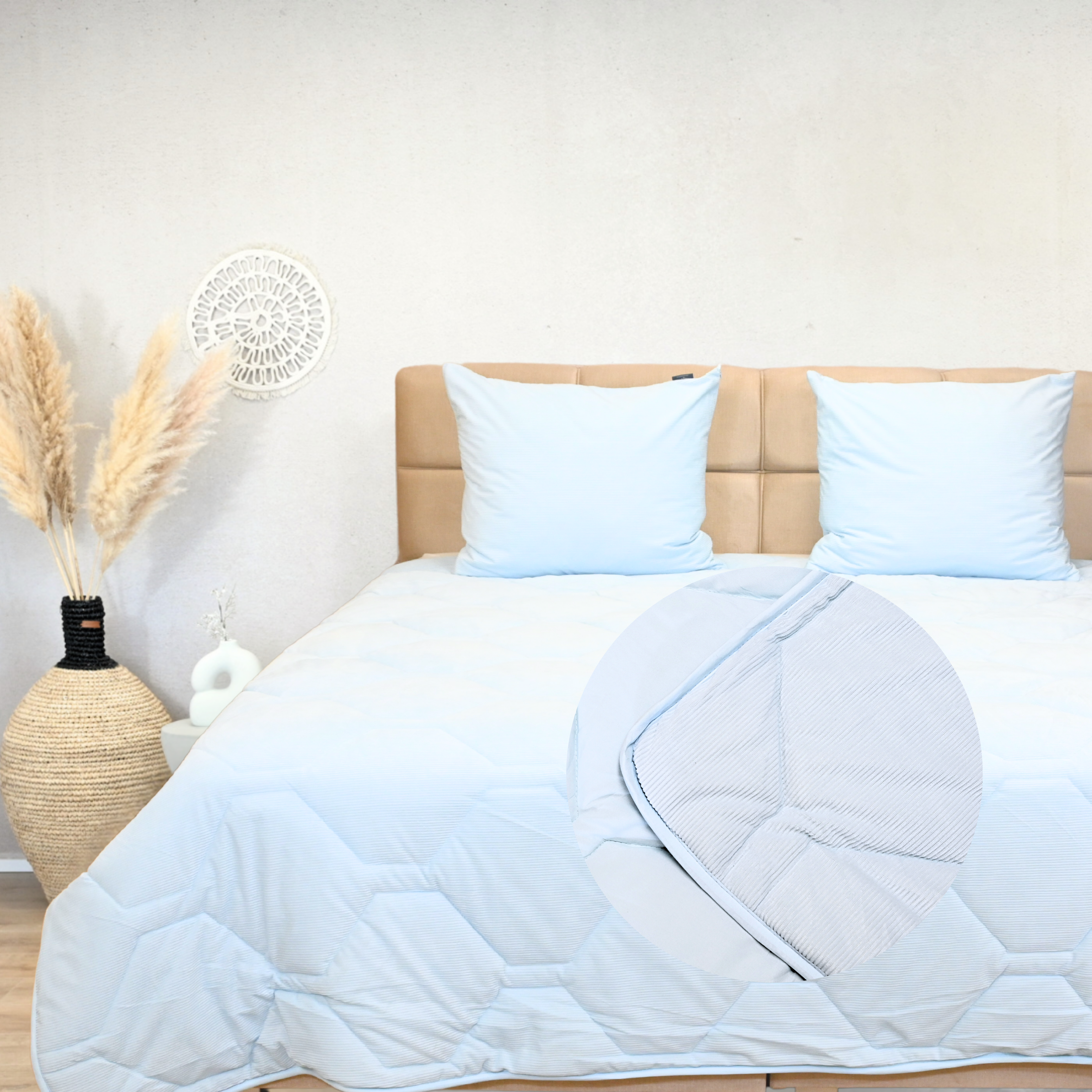 Ice Blue HappyBed Corduroy summer duvet on beige bed with decorative cushions and pampas in vase.