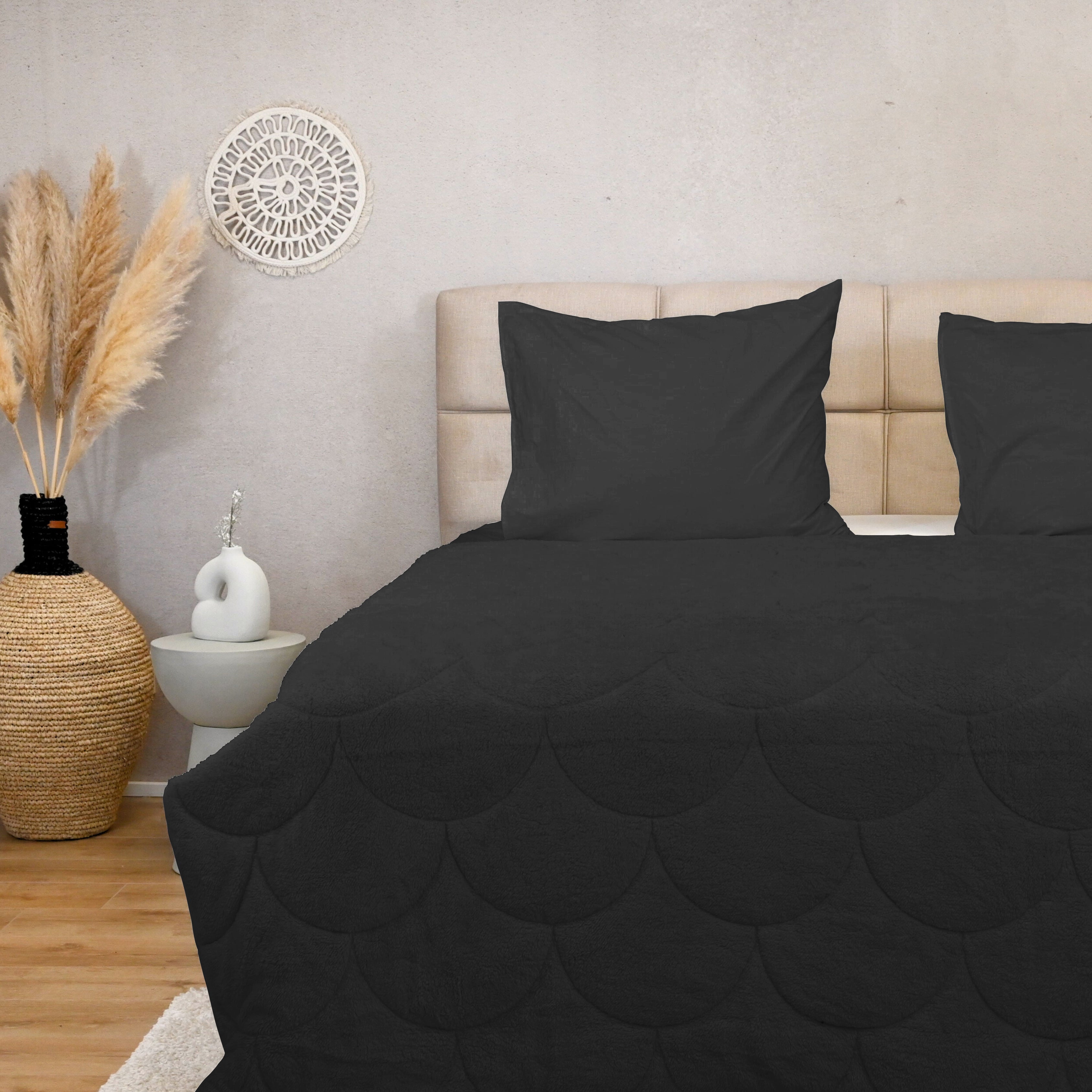 HappyBed Teddy Black year-round duvet on bed with pillows in cozy bedroom setting.