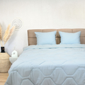 Light blue HappyBed Mousseline dekbed year-round breathable hypoallergenic comfort duvet on bed with matching pillows