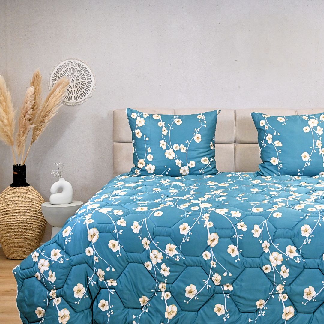 Blue floral duvet on bed, designed for year-round comfort with hypoallergenic and quick-dry features.