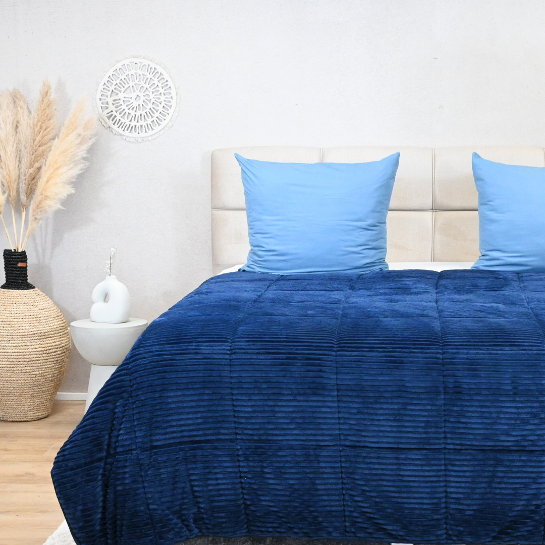 HappyBed ribbed blue duvet on bed, offers year-round comfort with microfibre and teddy-polyester textures.