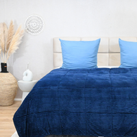 HappyBed ribbed blue duvet on bed, offers year-round comfort with microfibre and teddy-polyester textures.
