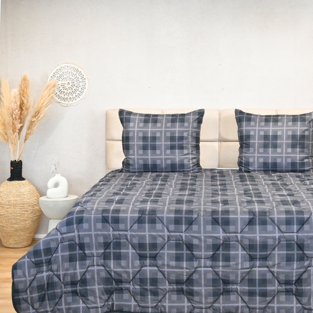 HappyBed Grey Tartan duvet set displayed on a neatly made bed with matching pillows, suitable for all seasons.