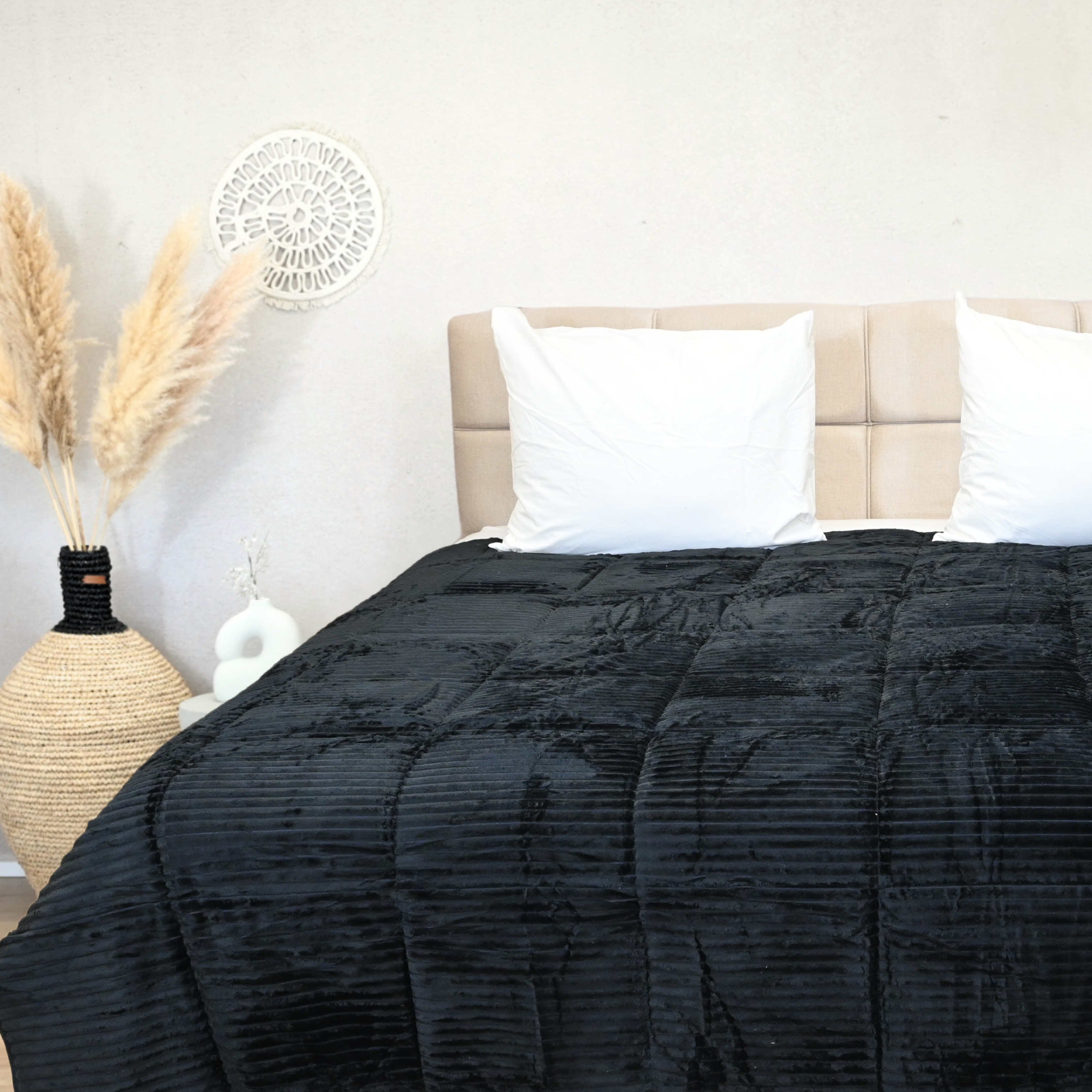 HappyBed Rib Black all-year duvet on bed with soft texture.