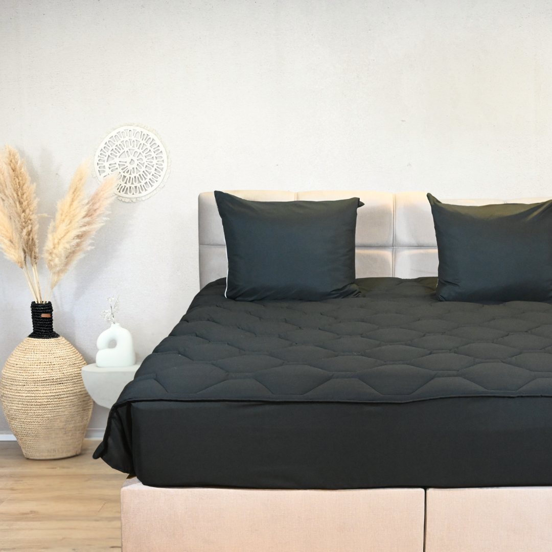 HappyBed Black all-season duvet with tuck-in strip on a bed, hypoallergenic and fast-drying.