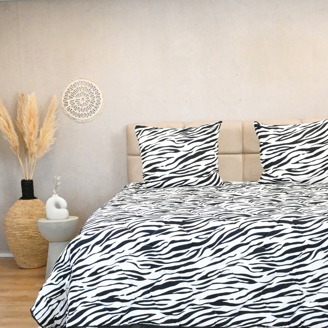 HappyBed Zebra summer duvet with zebra pattern on bed in cozy bedroom setting.