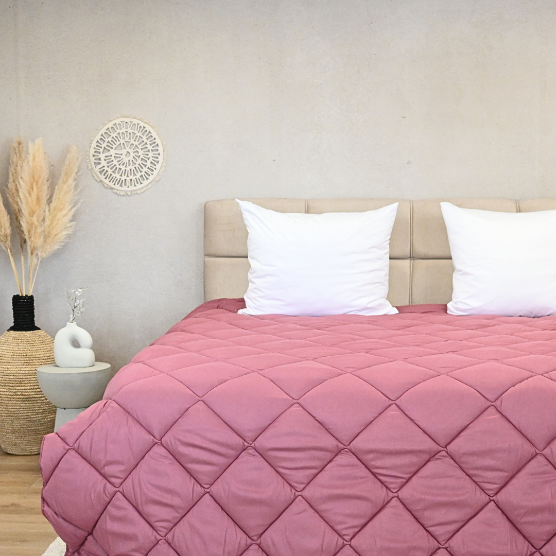 HappyBed Desert Rose all-season duvet, rosy quilted design on bed.