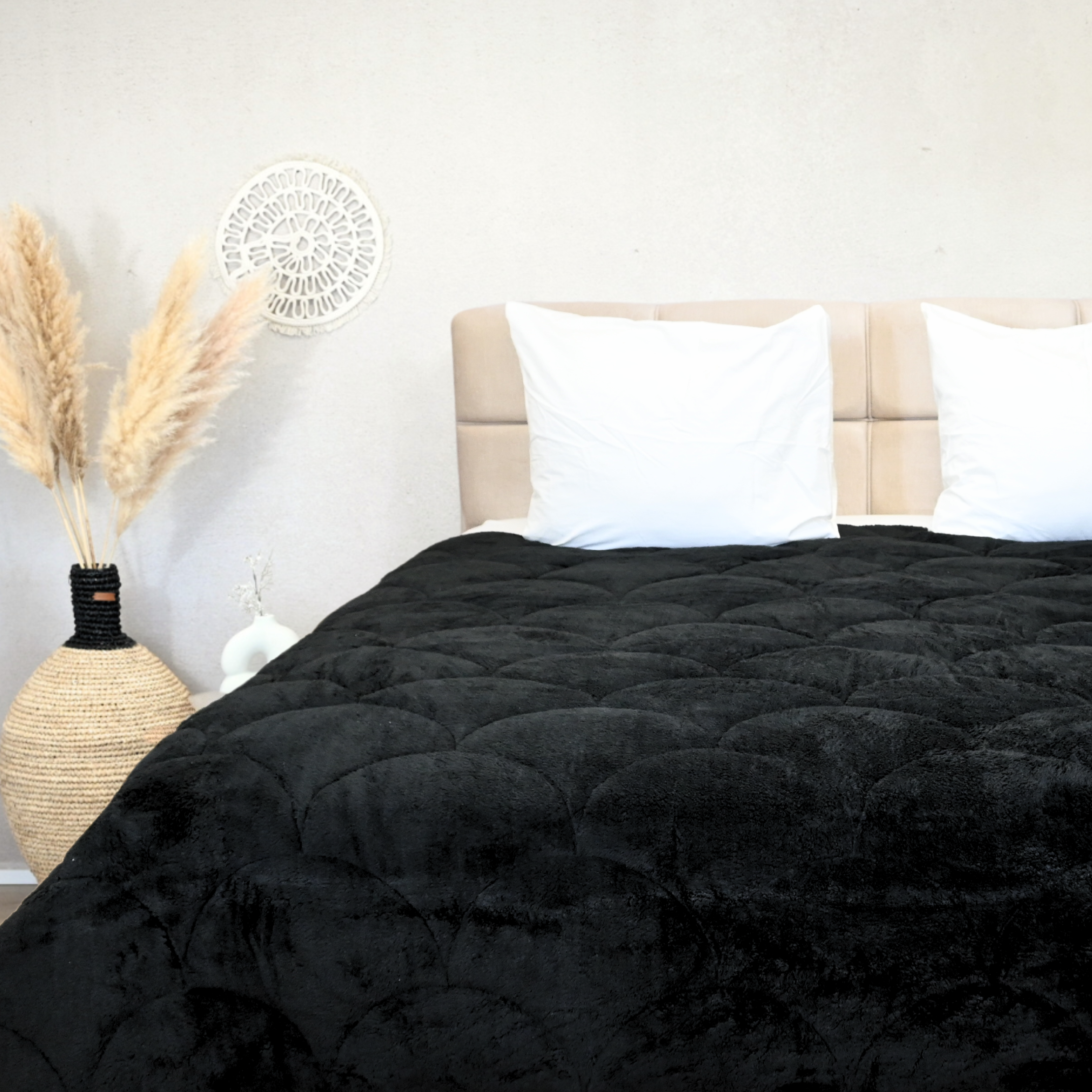 HappyBed black teddy design all-season duvet on a beige bed with white pillows.