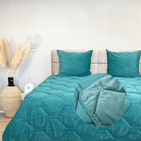 Emerald green HappyBed Corduroy duvet on bed with decorative pillows.